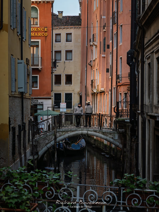 Authentic Scene of Venice — Gondoliers on a Historic Bridge